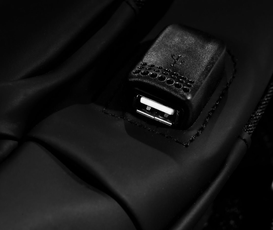 Hitoki Essentials Bag featuring USB charging port for on-the-go charging with a portable battery pack.