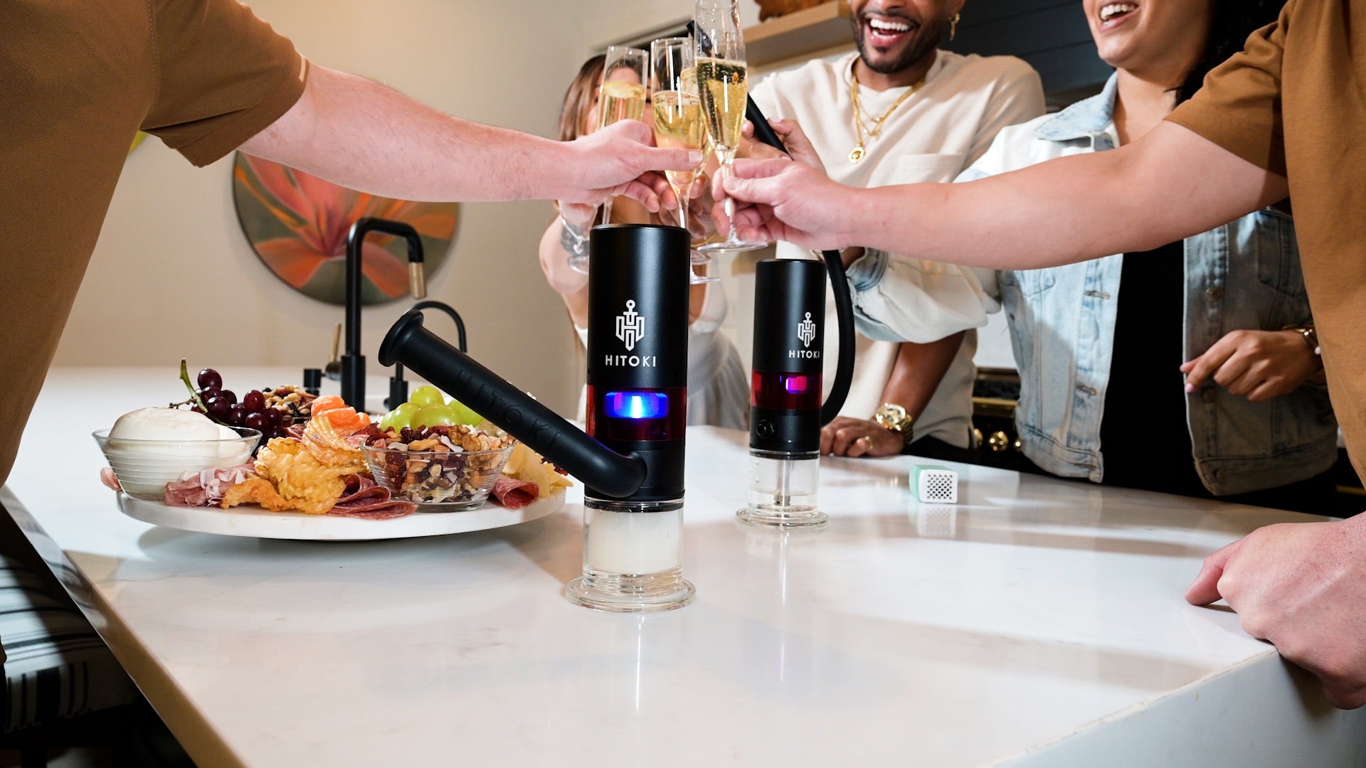 Group cheers around two Hitoki Trident V3 with hookah hoses, showing social, customizable use