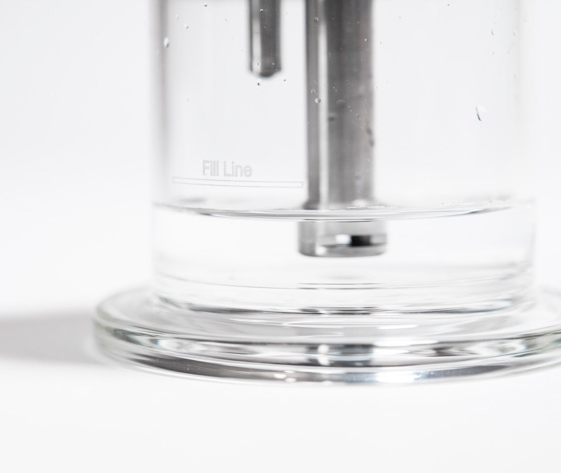 Close-up of Trident V3 glass water base showing fill line and inner stem