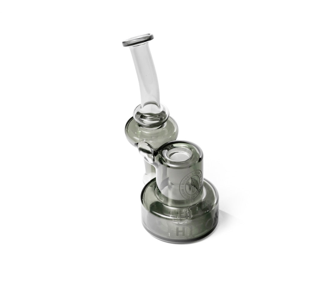 Angled view of Hitoki Saber Recycler Attachment showing contoured neck and refined transparent glass craftsmanship.