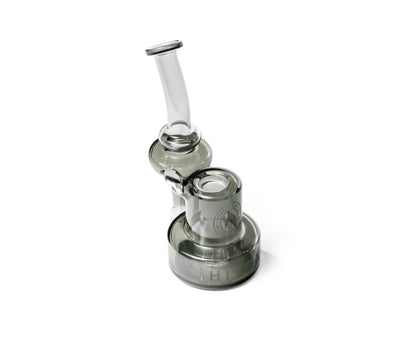 Angled view of Hitoki Saber Recycler Attachment showing contoured neck and refined transparent glass craftsmanship.