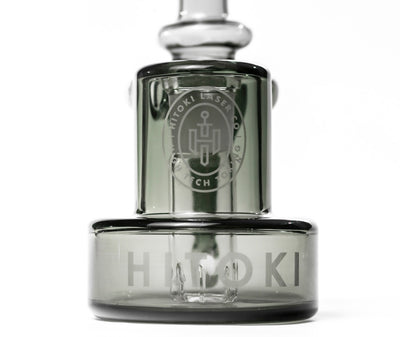 Close-up of Hitoki Saber Recycler Attachment showcasing etched logo and precision-crafted glass base design.