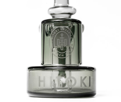 Close-up of Hitoki Saber Recycler Attachment showcasing etched logo and precision-crafted glass base design.