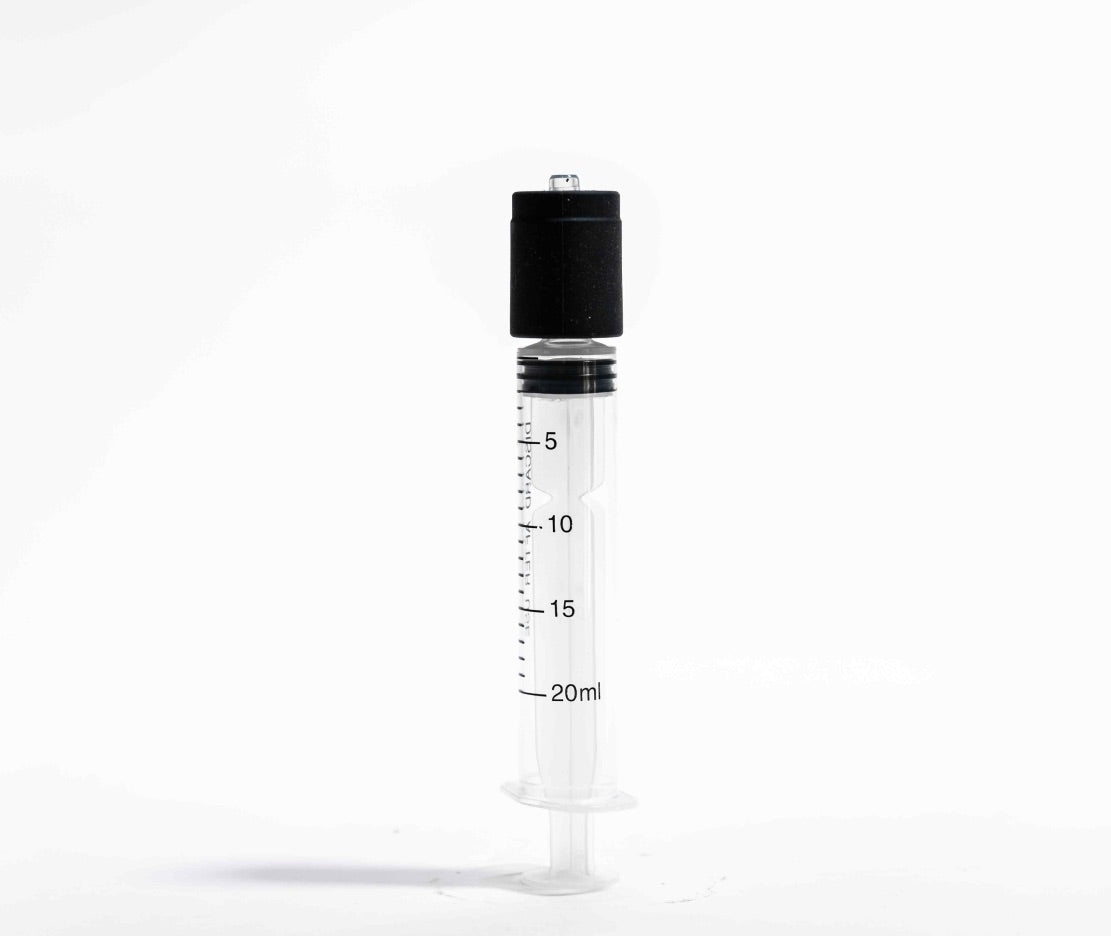 Hitoki Cleaning Kit syringe standing upright with black adapter for Trident and Saber maintenance.