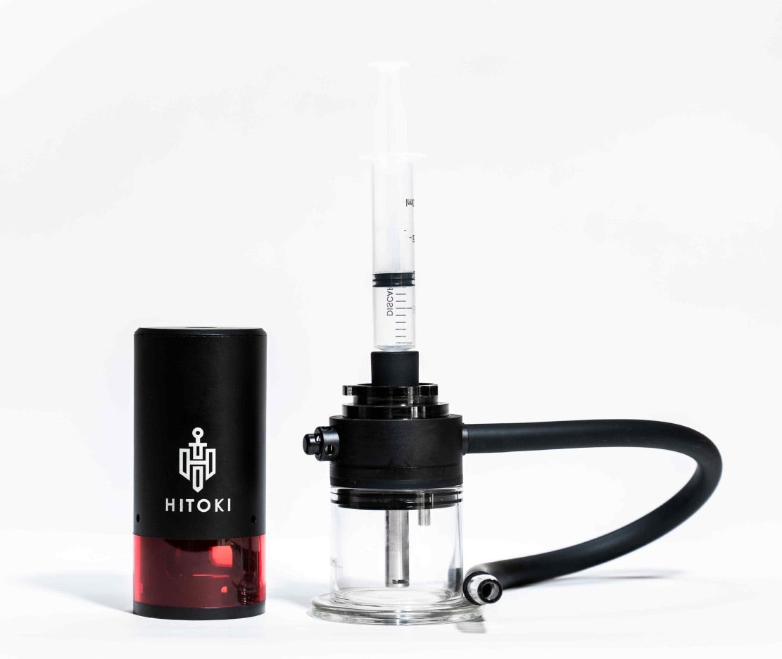 Hitoki Cleaning Kit attached to Trident device loading chamber with syringe and adapter in cleaning position.
