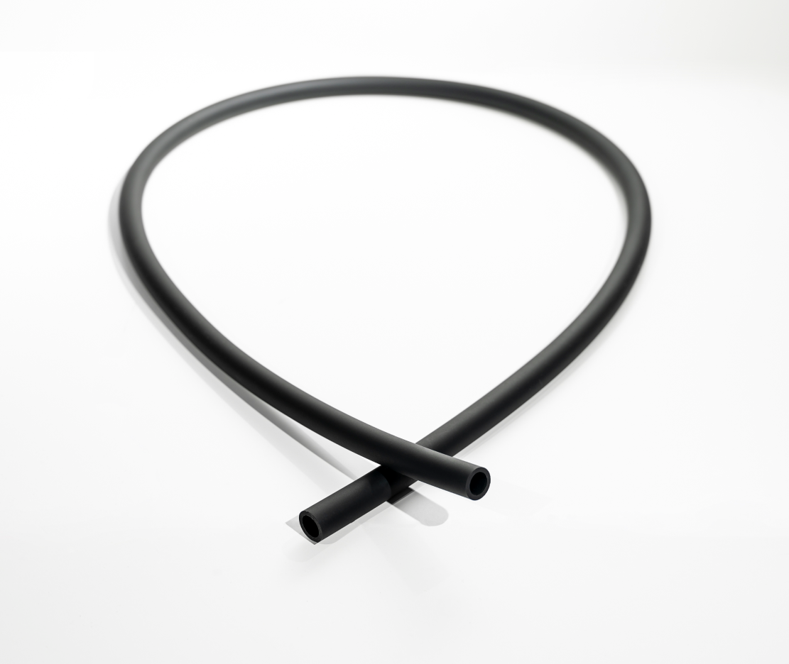 Coiled Hitoki Trident Hose in black, demonstrating flexibility and design.